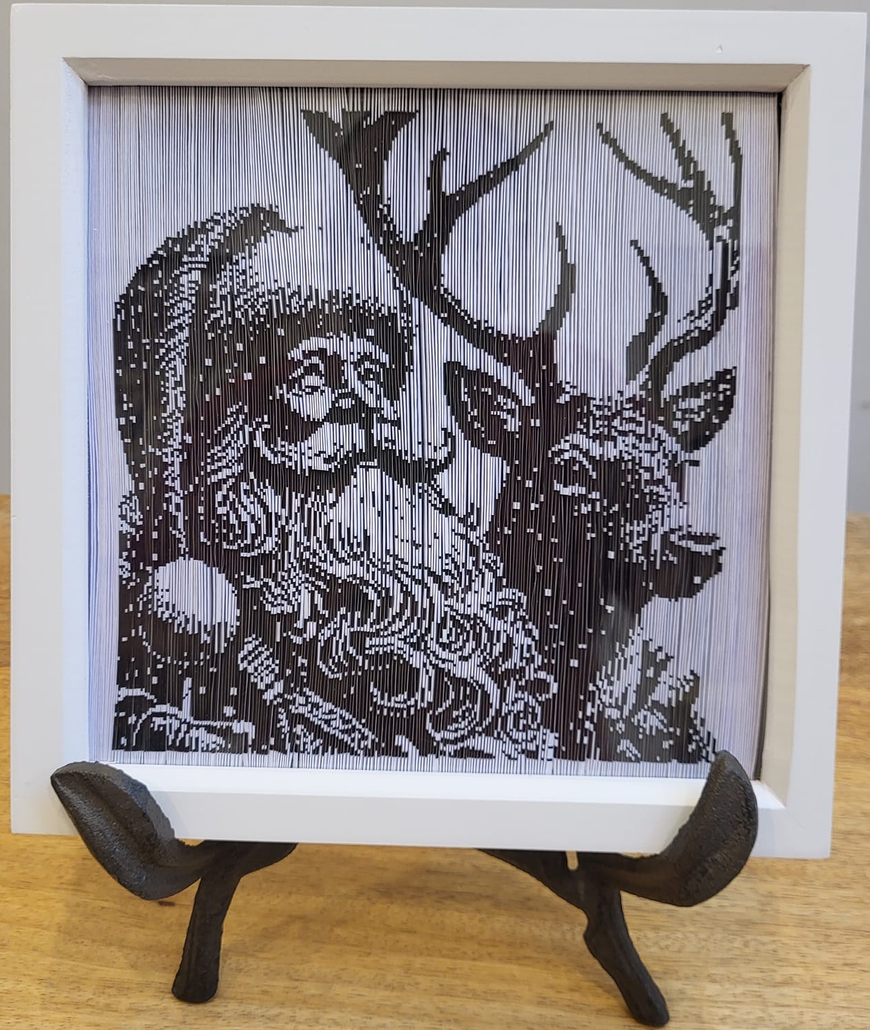 Framesmart Cut Out Frame Pattern example depicting an image of Santa Claus and a Reindeer. The image is within a square white deep box frame on a stand.