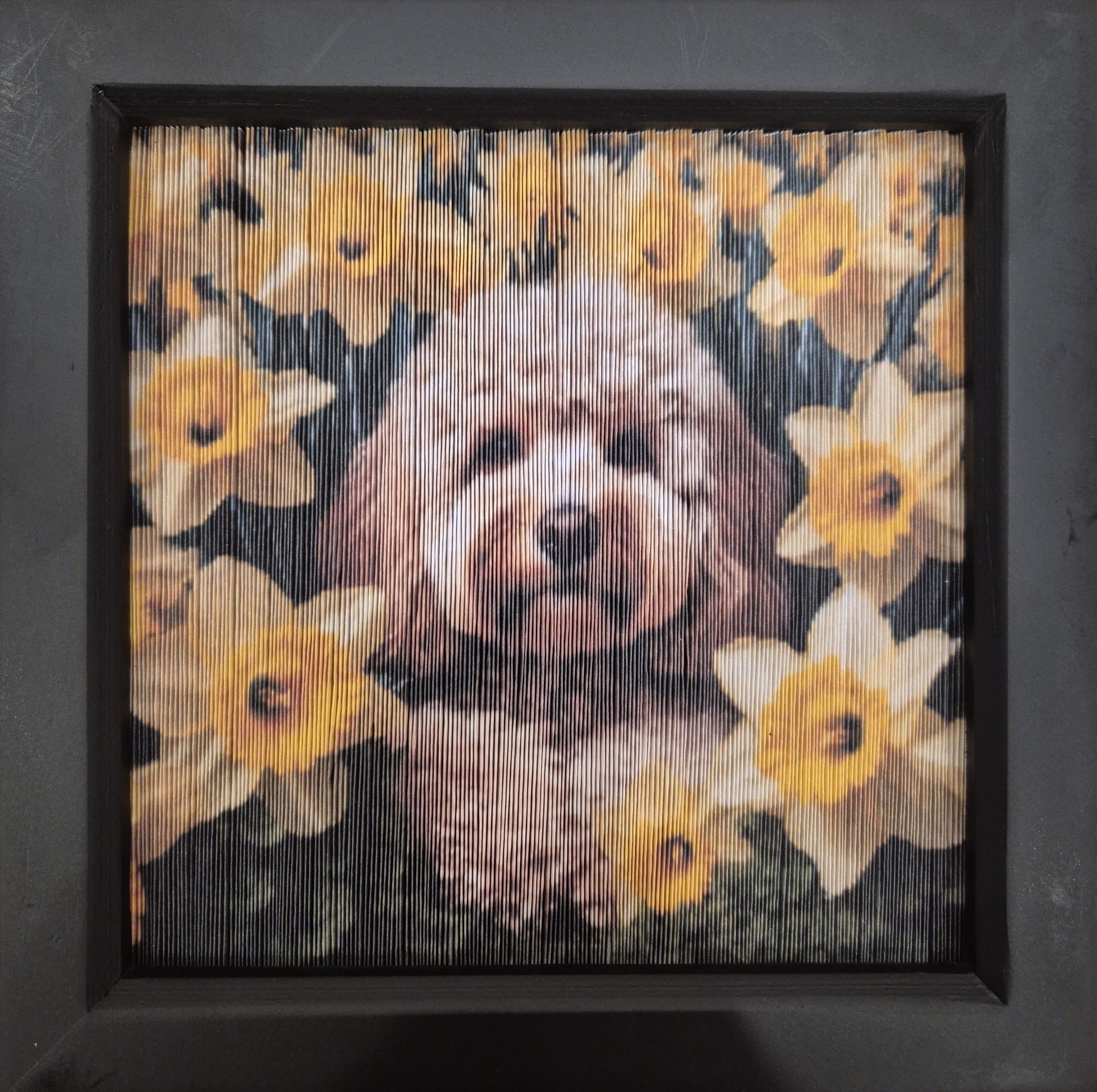 Completed fore-edge folded paper frame of a dog with daffodils created using Framesmart pattern maker